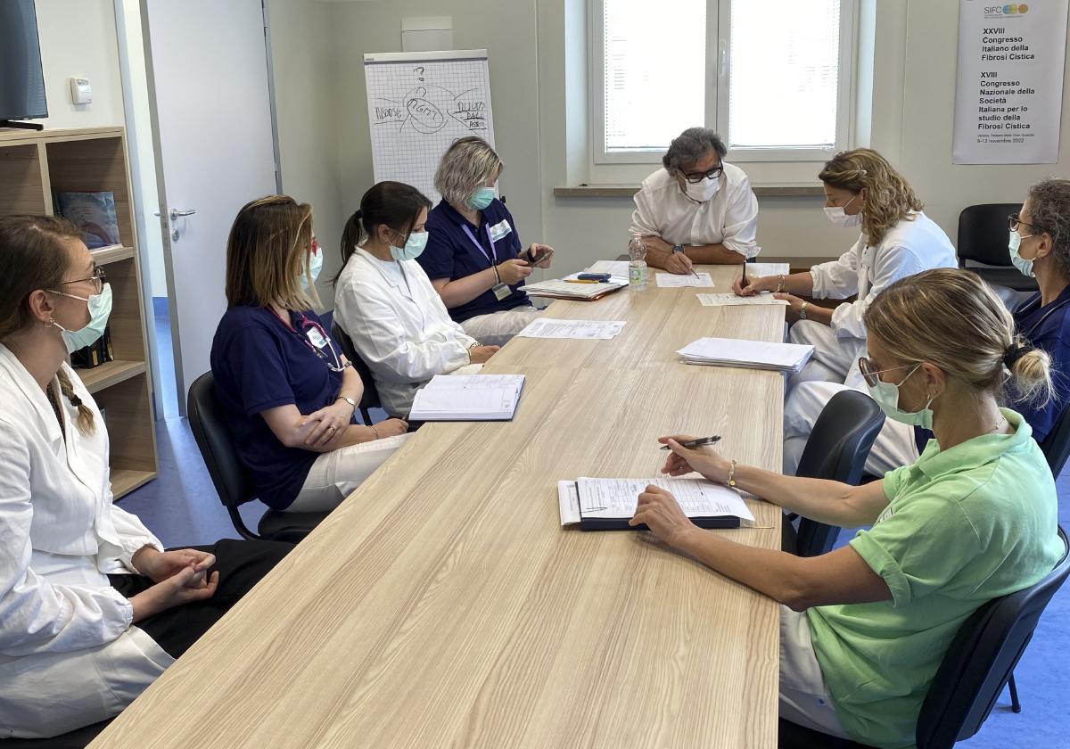 Group of Center staff gathered around a table during a meeting on quality